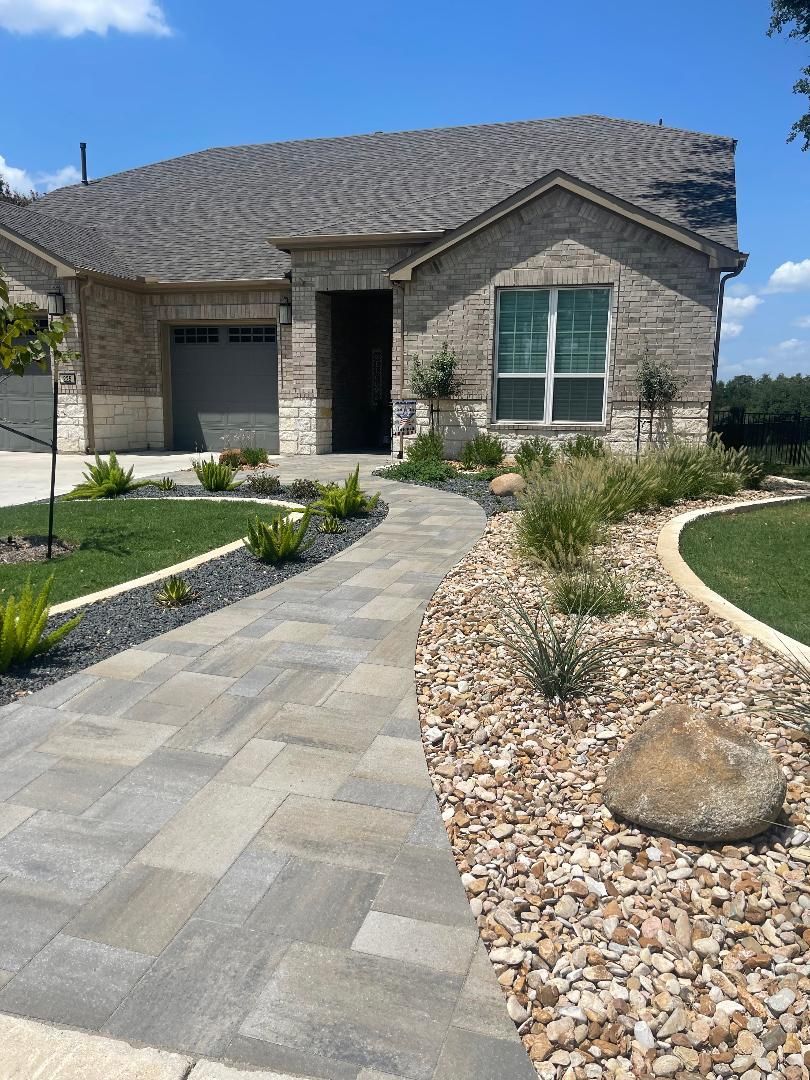 A brick house with a stone walkway leading to it.