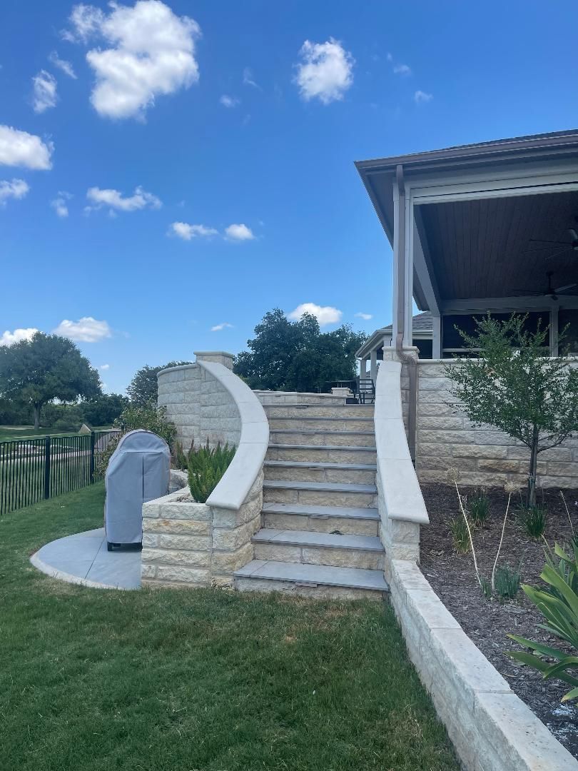 A set of stairs leading up to a house on a sunny day.
