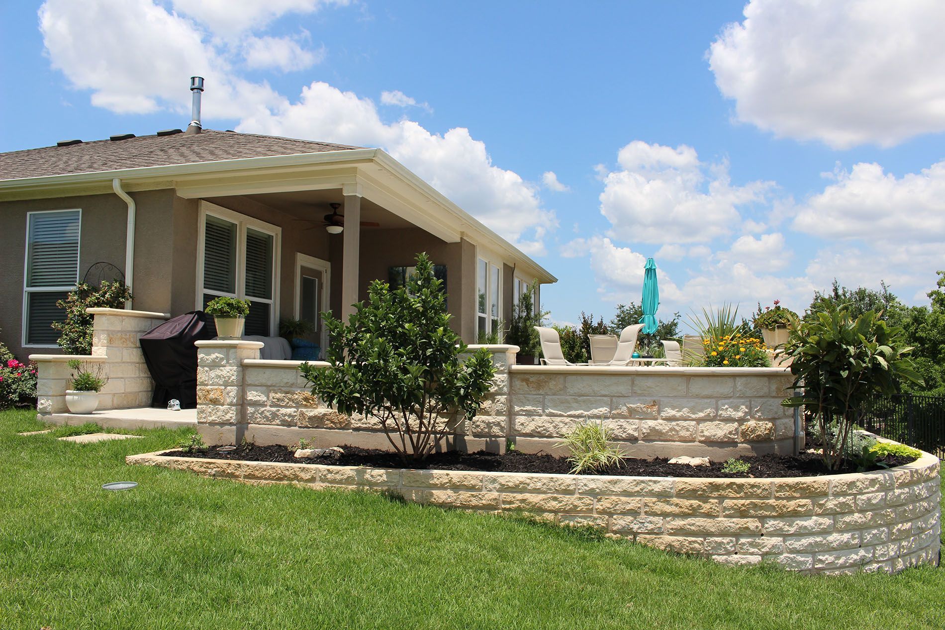 A house with a brick wall in front of it
