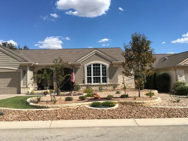 A house with a large window and a flag in front of it