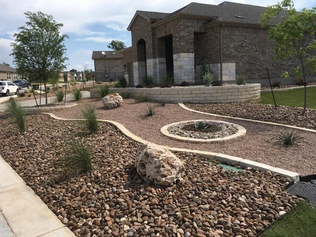A stone walkway with a fire pit in the middle of it