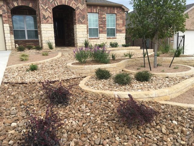 A house with a lot of rocks in front of it