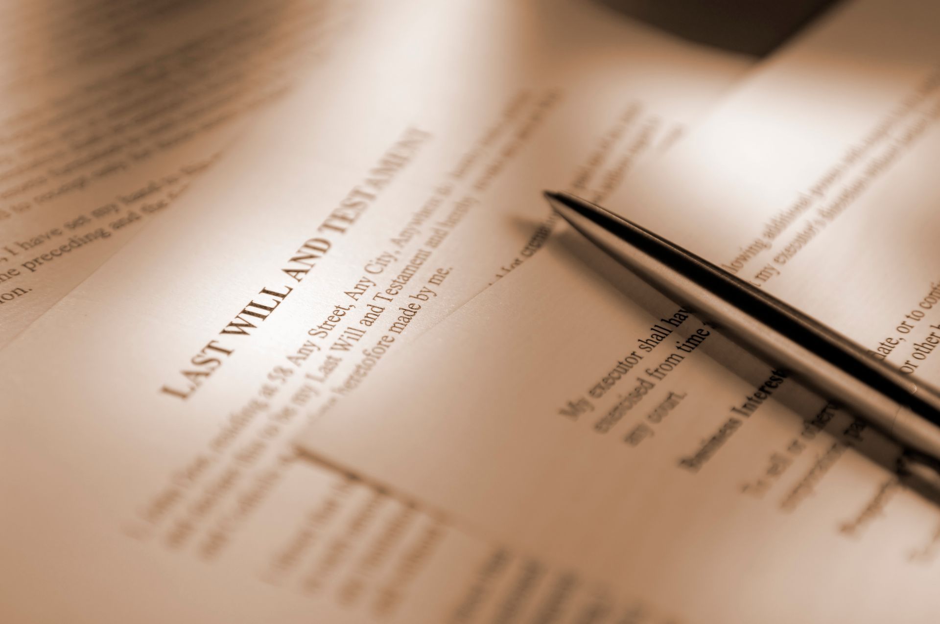 Last will and testament document with a pen resting on it.