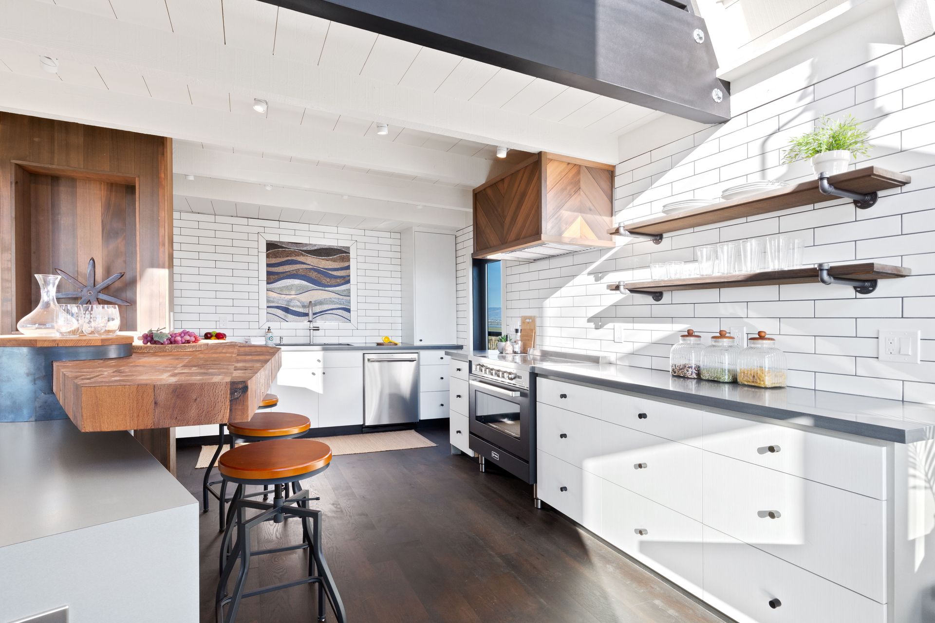 Modern kitchen with white brick walls, wooden accents, and stainless steel appliances.