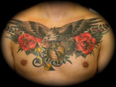 A man has a tattoo of an eagle and roses on his chest