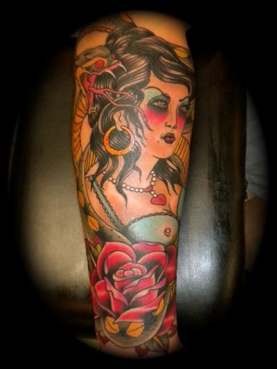A tattoo of a woman with a rose on her arm