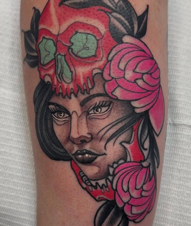 A tattoo of a woman with a skull on her head