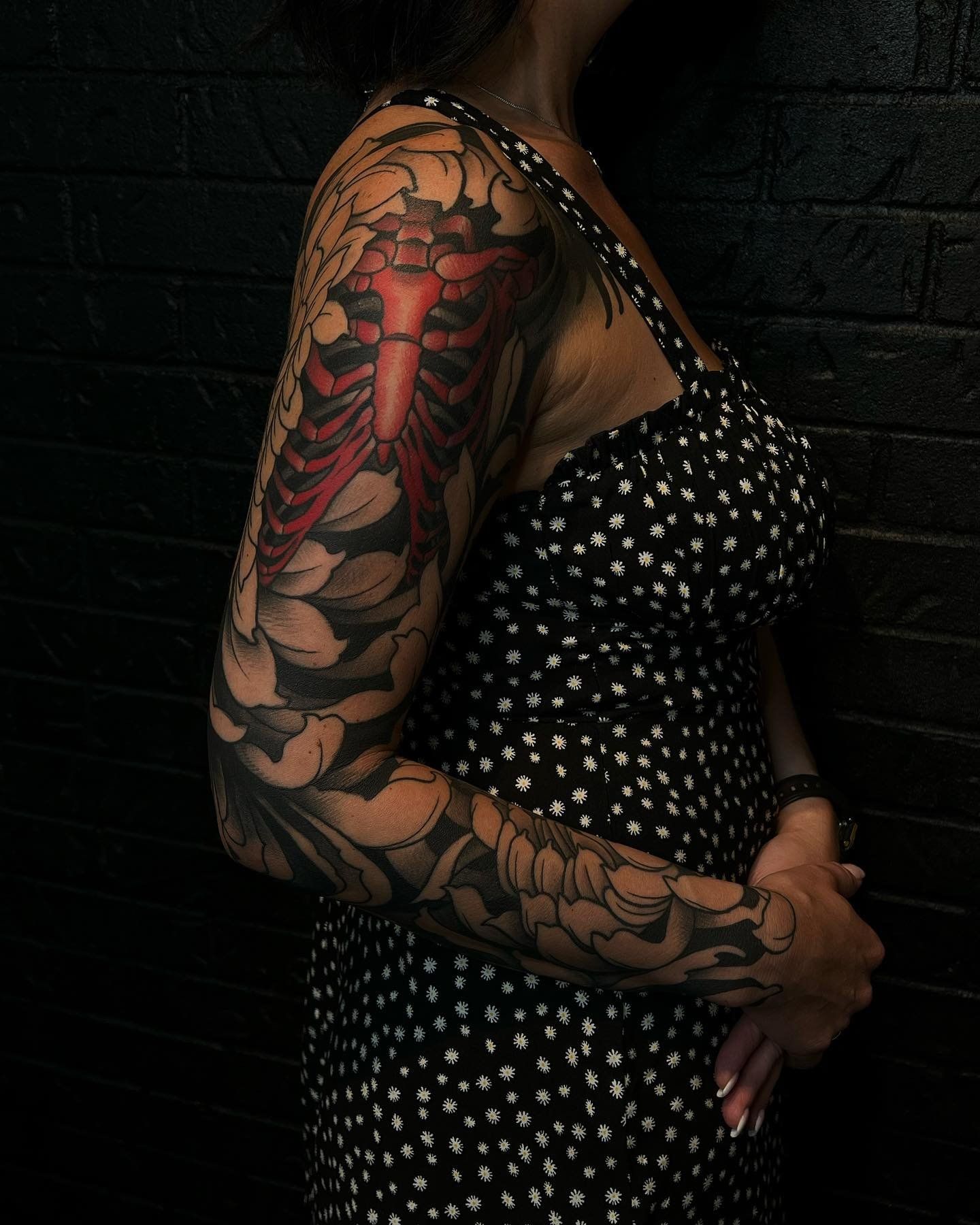 A woman with a skeleton tattoo on her arm