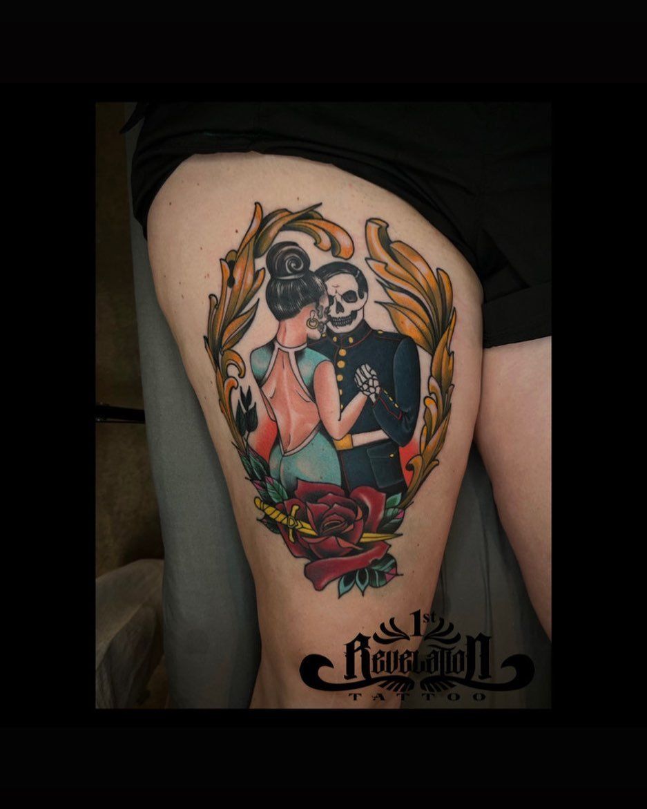 A woman has a tattoo of a skeleton and a woman on her thigh