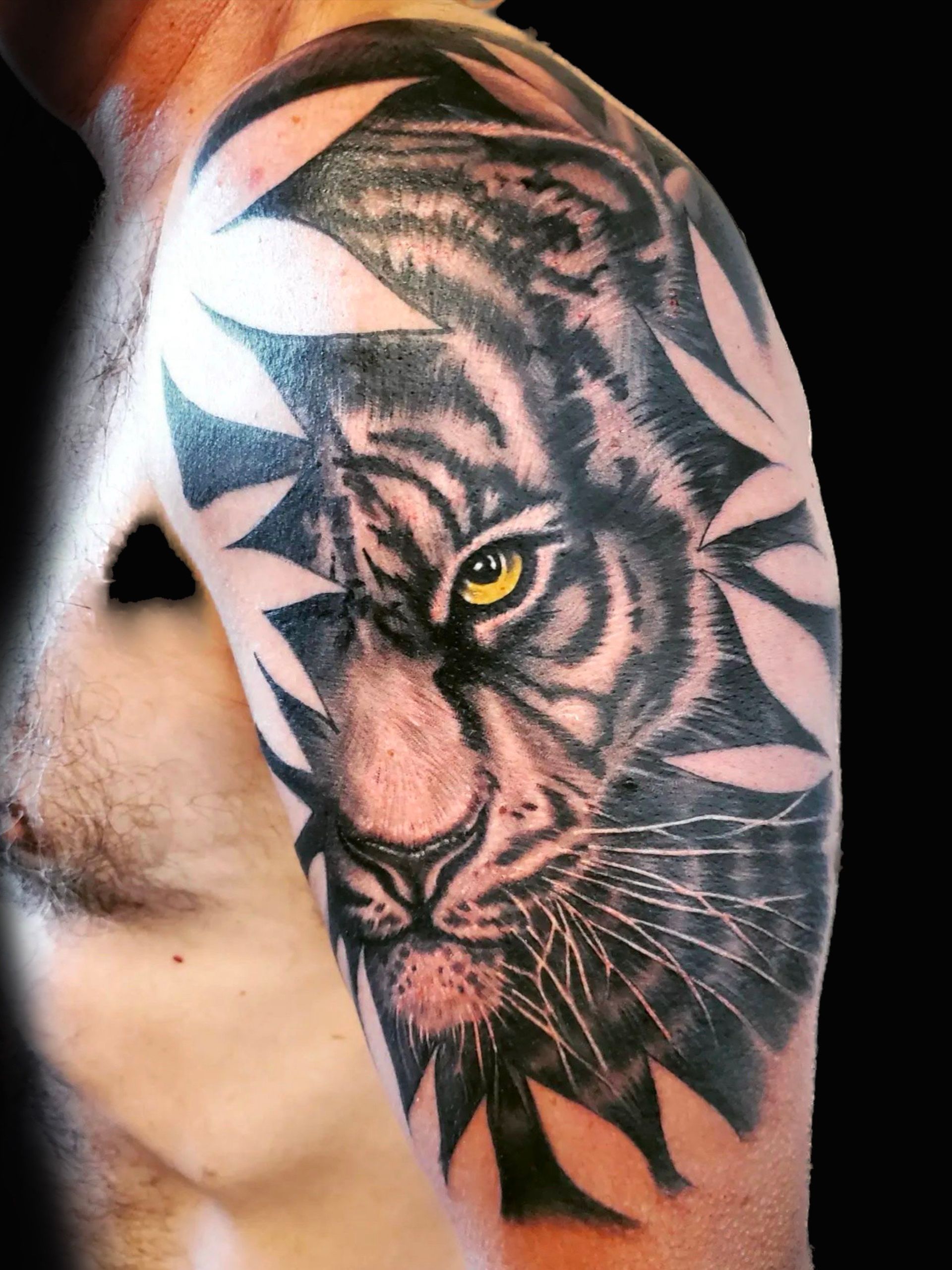 A man has a tattoo of a tiger on his arm