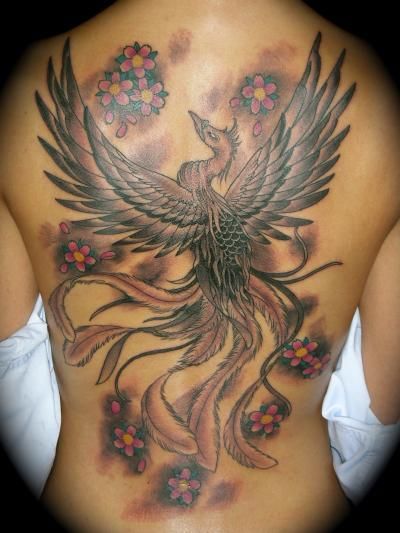 A woman has a phoenix tattoo on her back