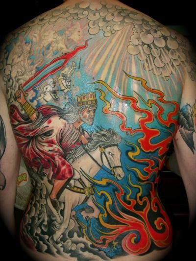 A man has a full back tattoo of a man riding a horse