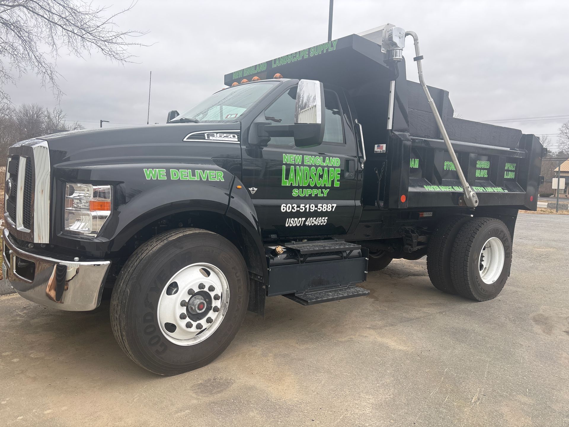 A black truck is parked in a parking lot.