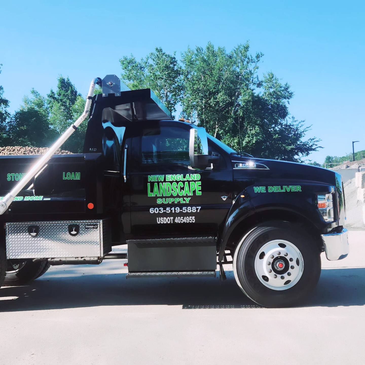 A dump truck with the word landscape on the side