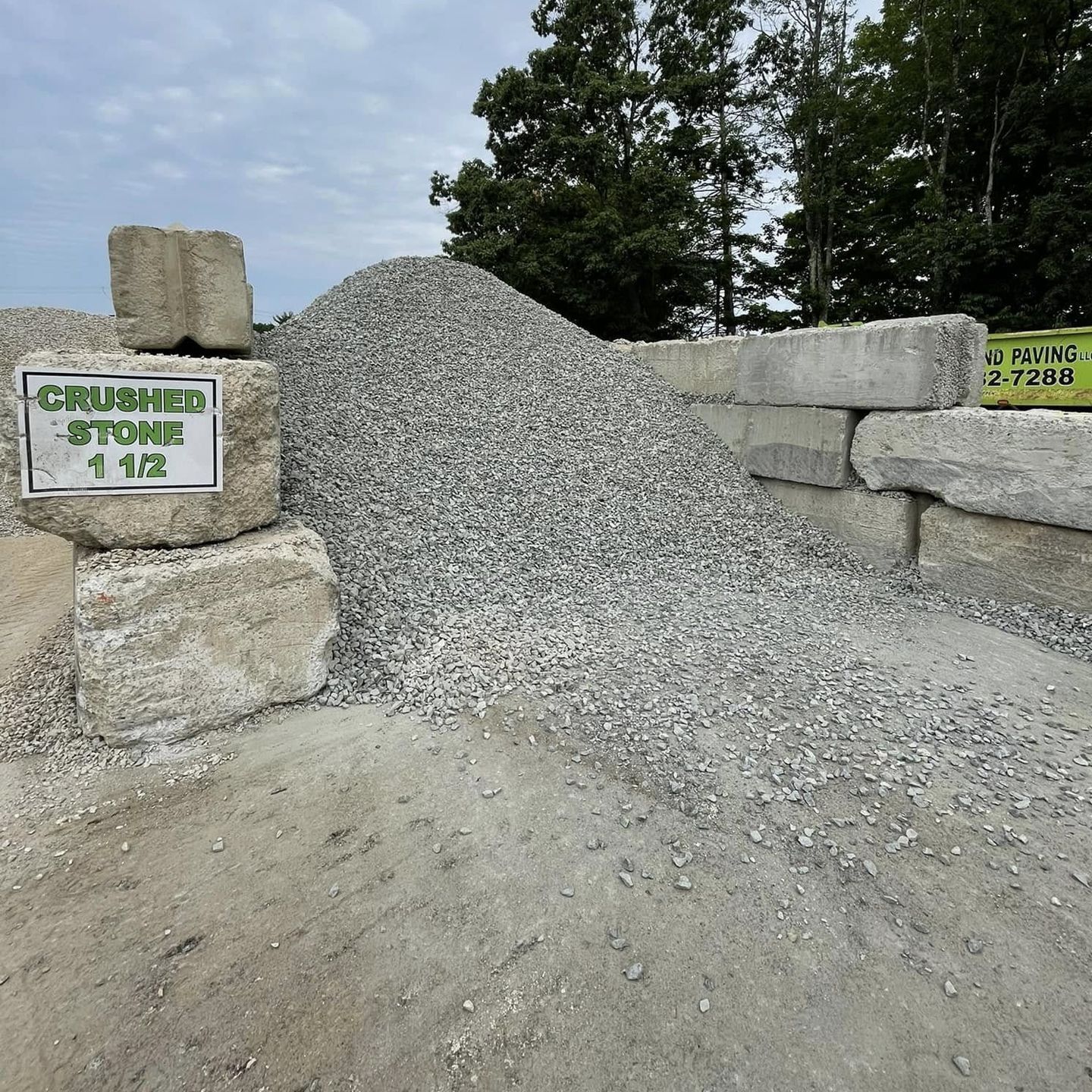 A pile of gravel with a sign that says crushed stones