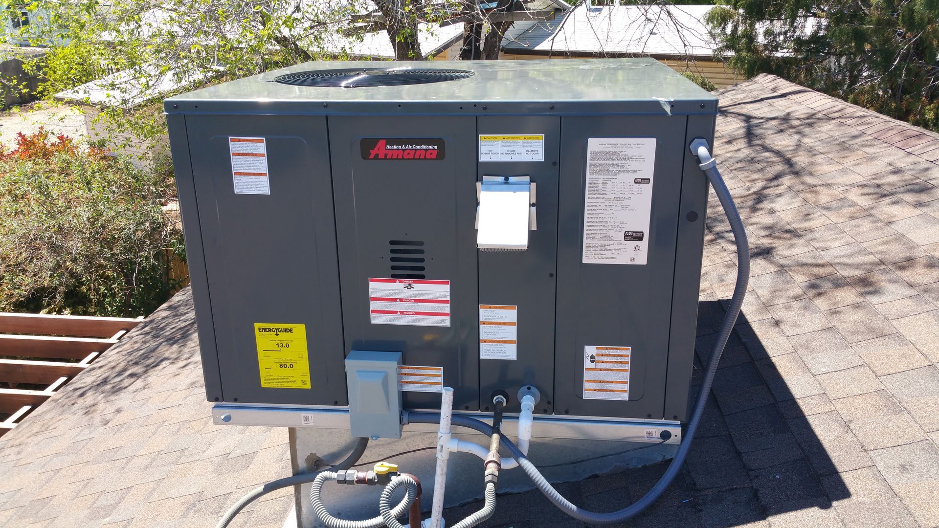 An air conditioner is sitting on top of a roof.