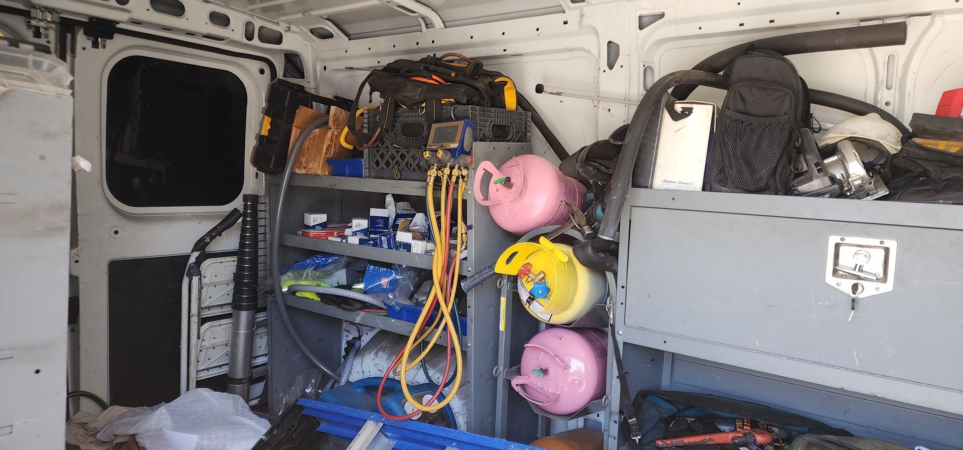 The inside of a van filled with lots of tools and equipment.