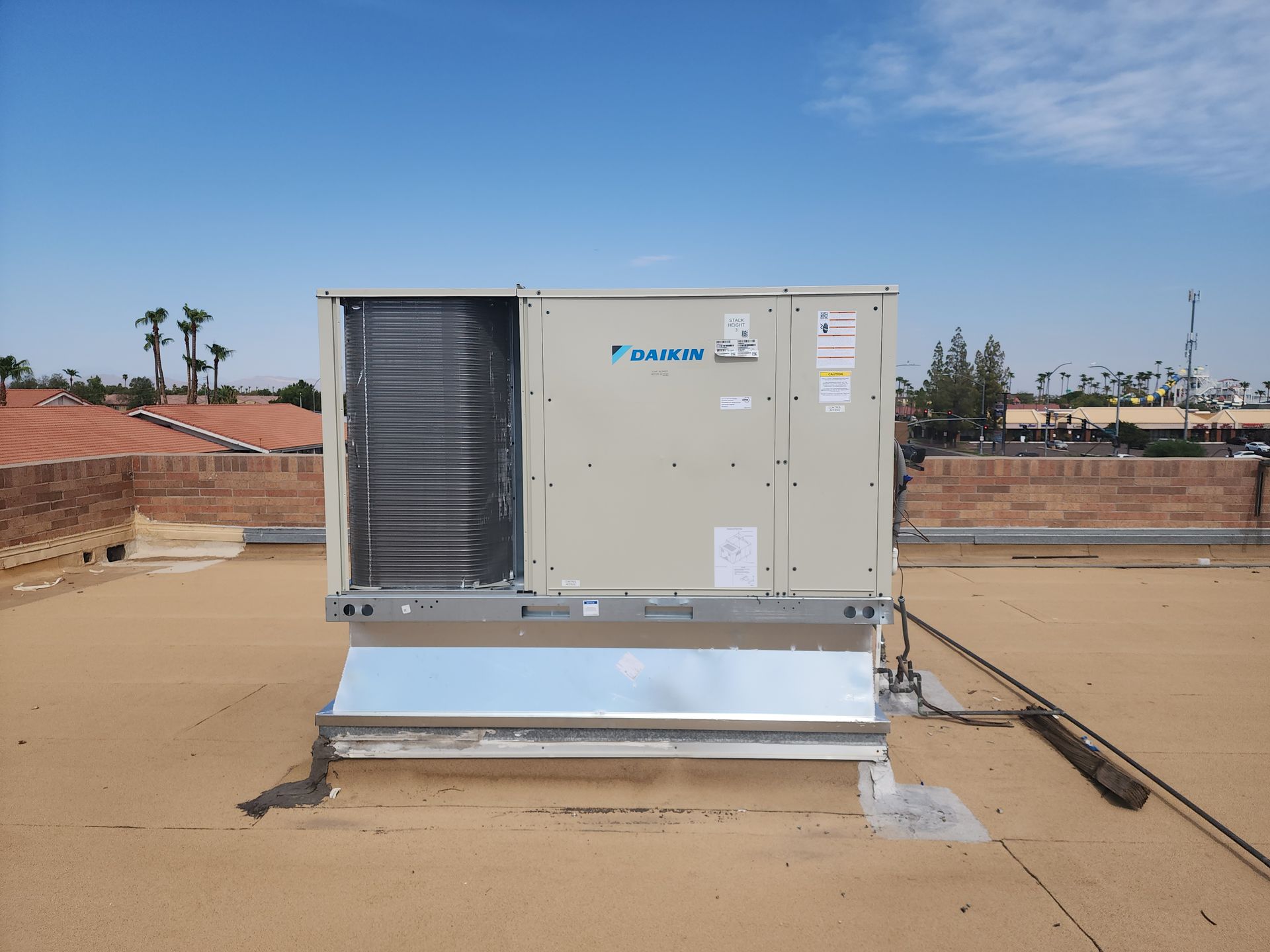 A large air conditioner is sitting on top of a roof.