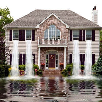 A large house with a fountain in front of it