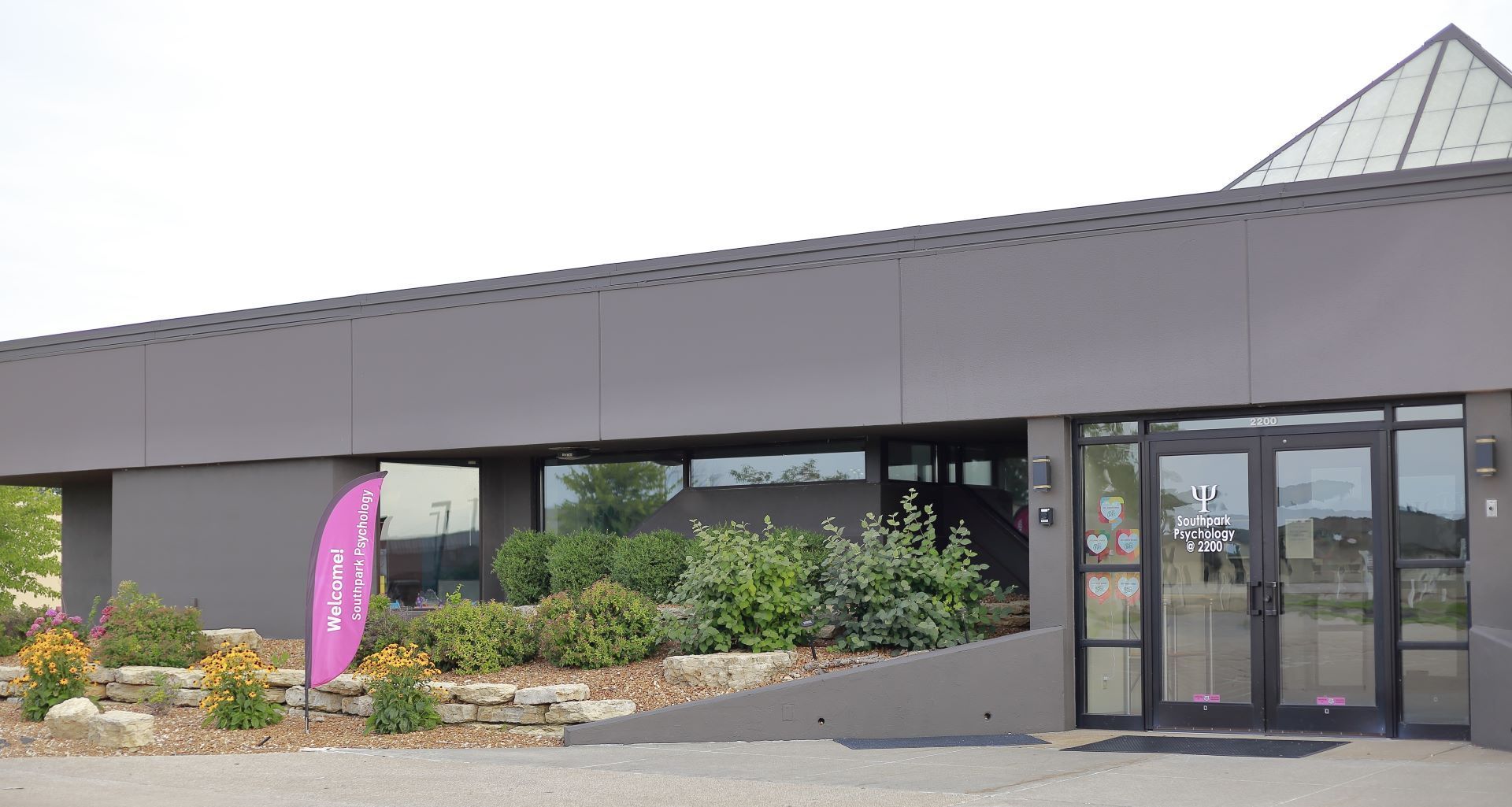 A large building with a pink flag in front of it