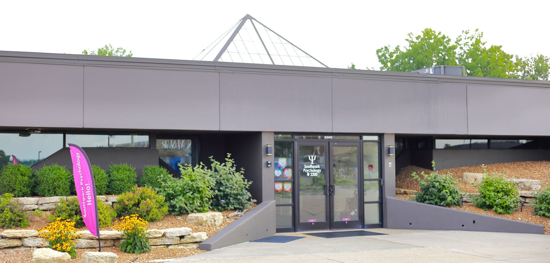 A large building with a purple flag in front of it