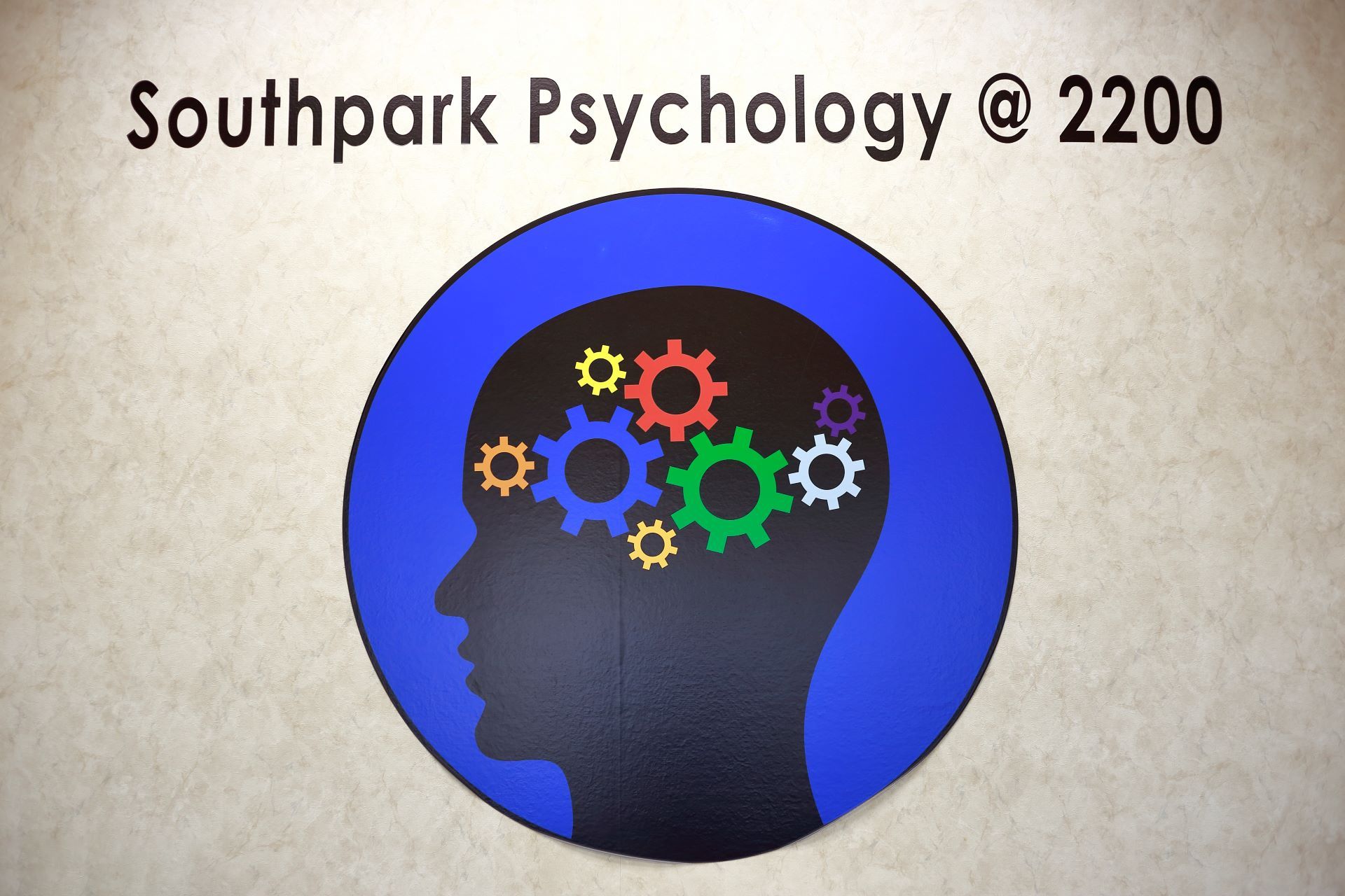 A logo for southpark psychology shows a head with gears in it