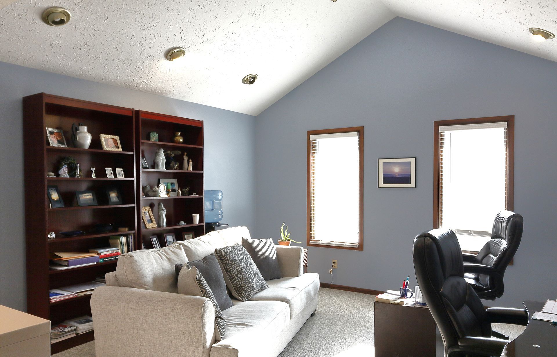 A living room with a vaulted ceiling and a couch in Southpark Psychology, 2100 facility