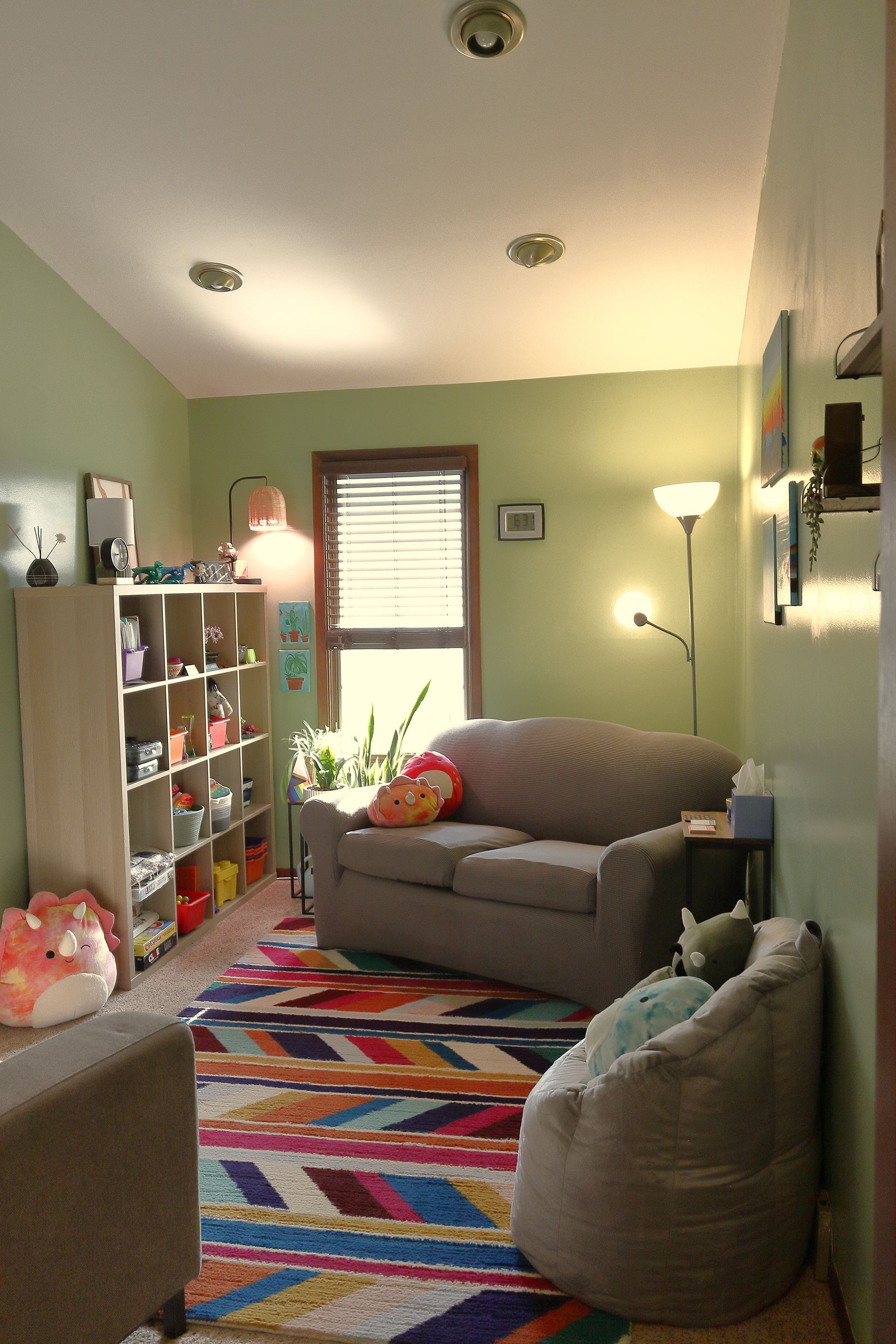 A living room with a couch and bean bag chairs. - Sara Hott