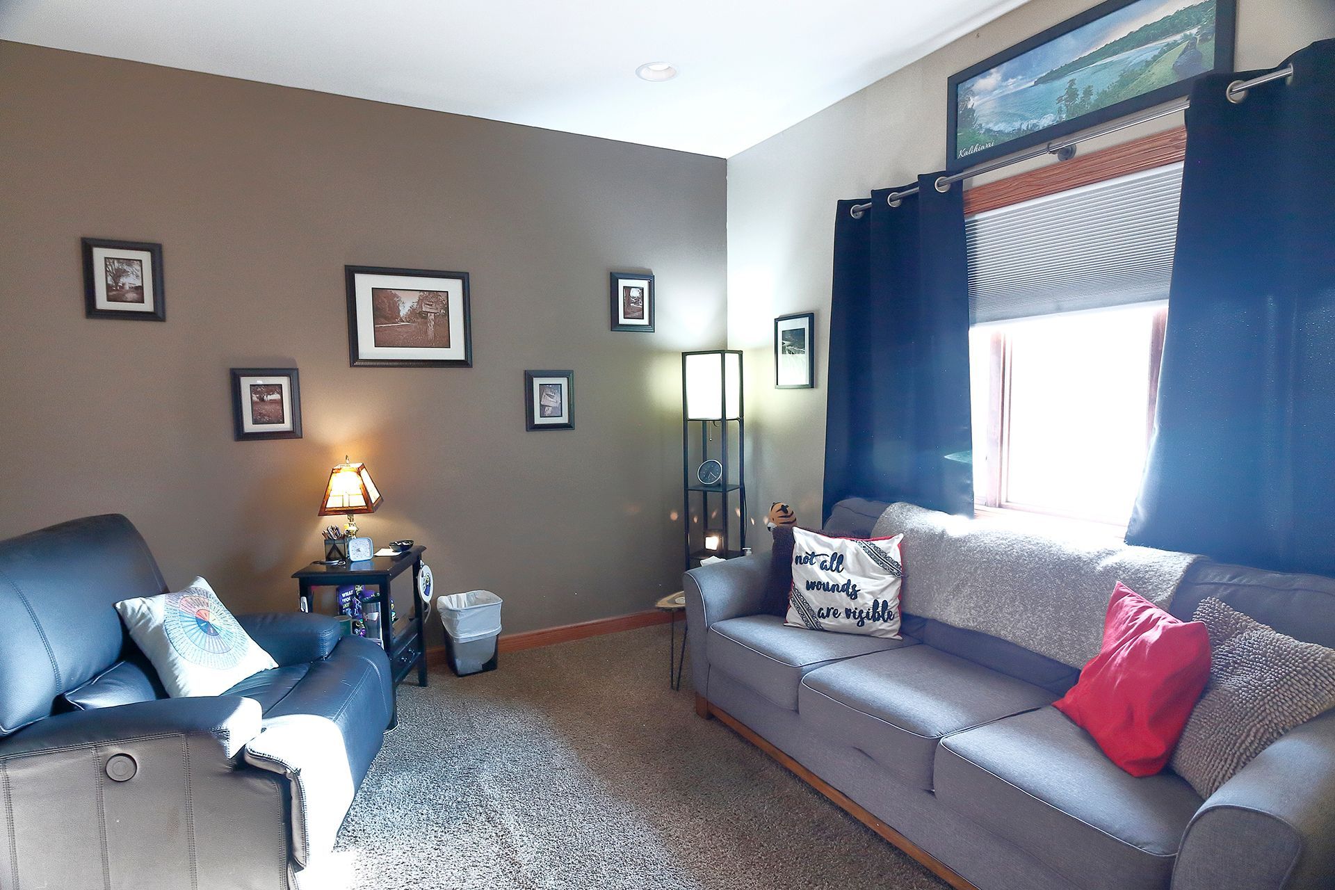 A living room with a couch and a chair. - Tom