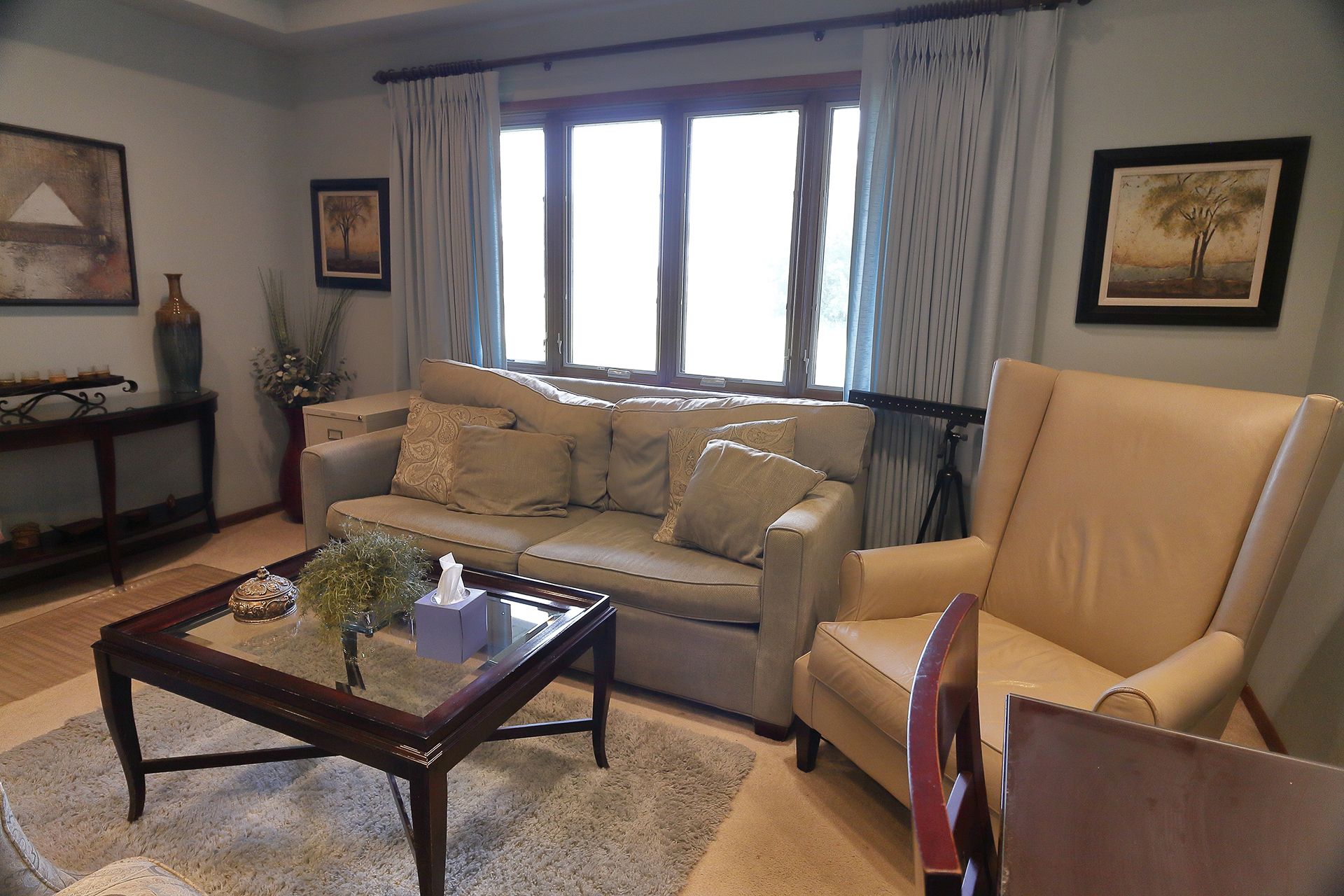 A living room with a couch a chair and a coffee table. - Dr. Lash