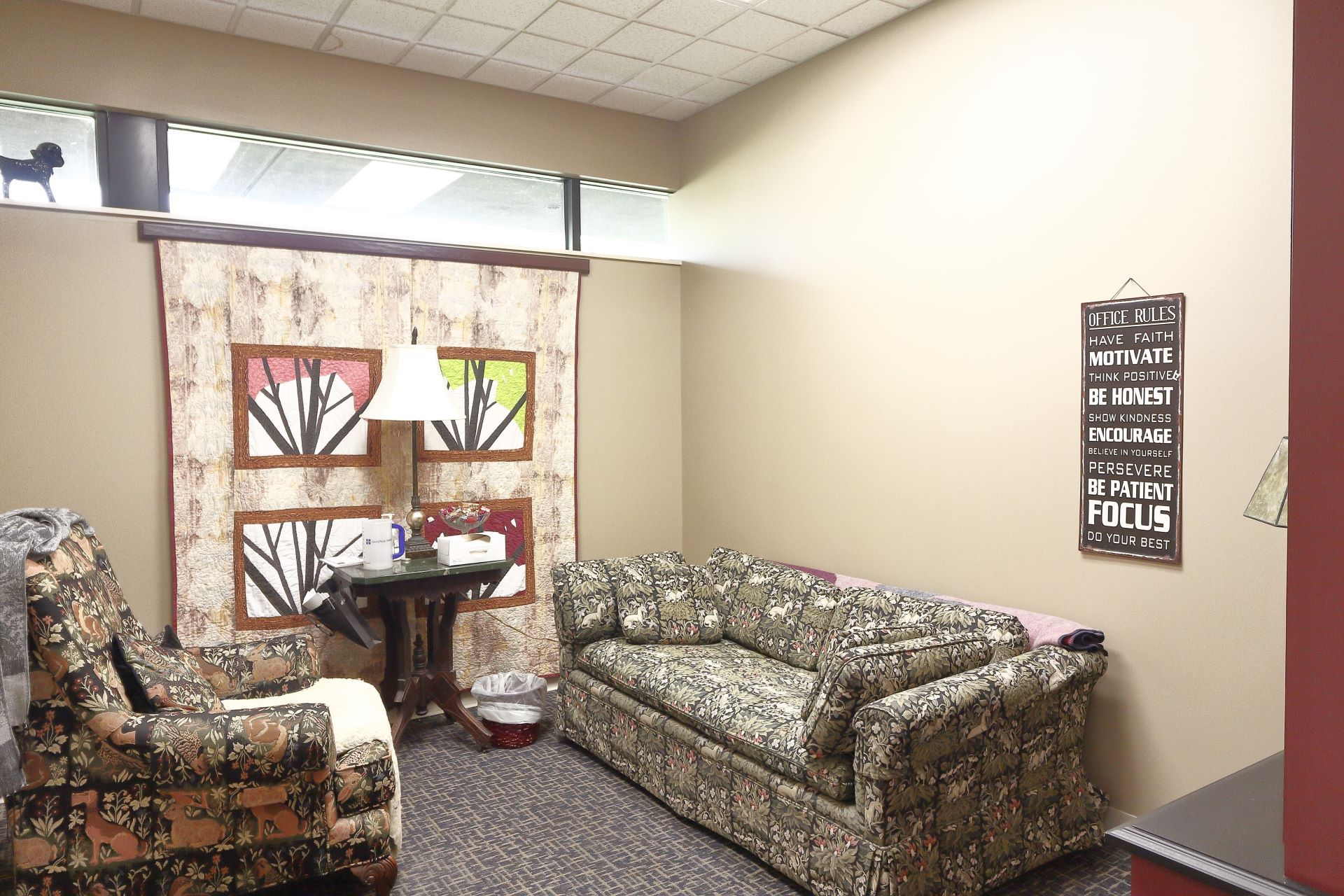 A living room with a couch and two chairs