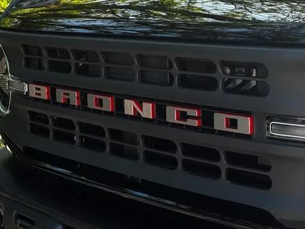 Close-up of a black Ford Bronco grille with red BRONCO lettering