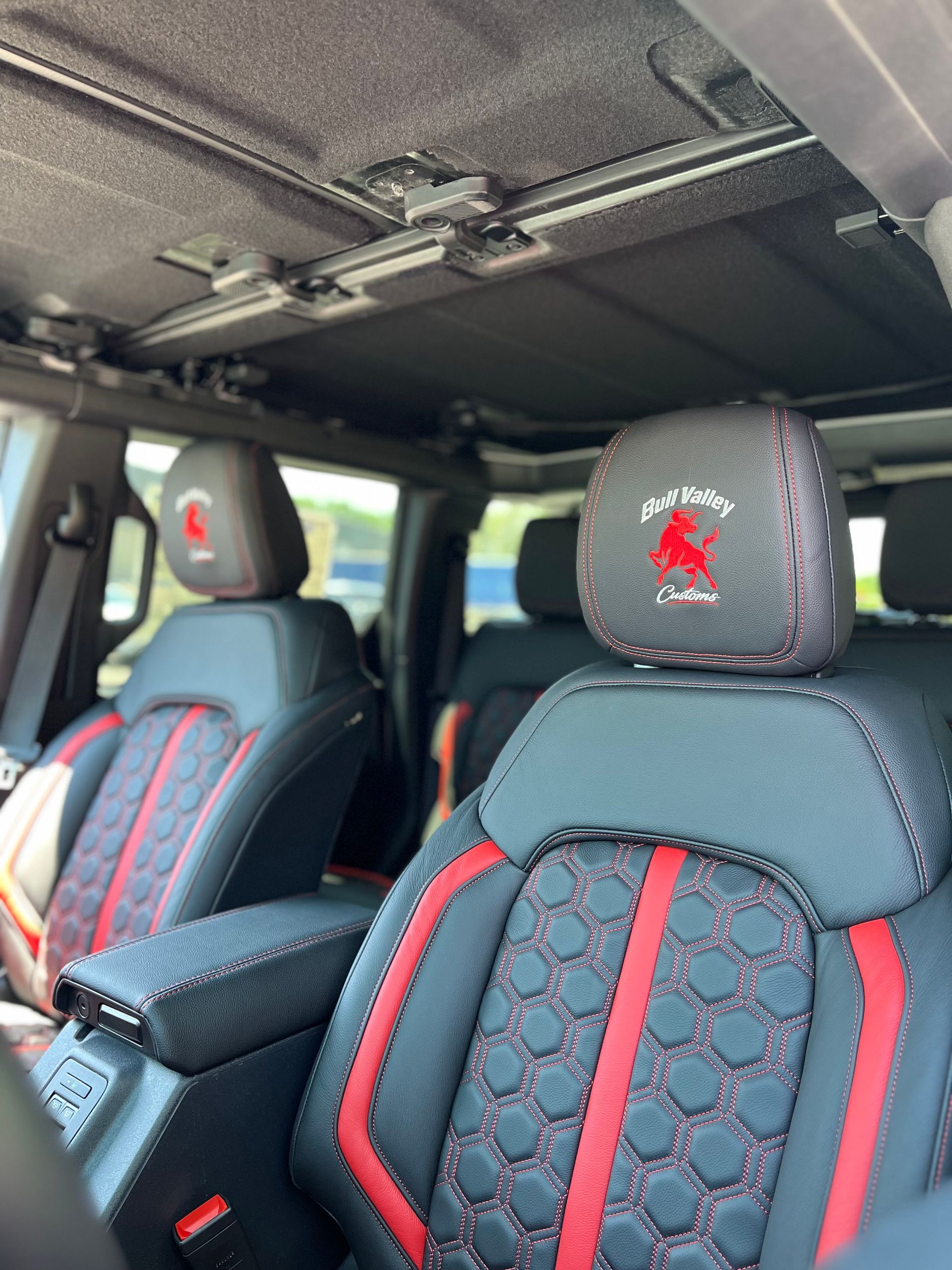 Car interior, custom front seats, and a gray roof lining.