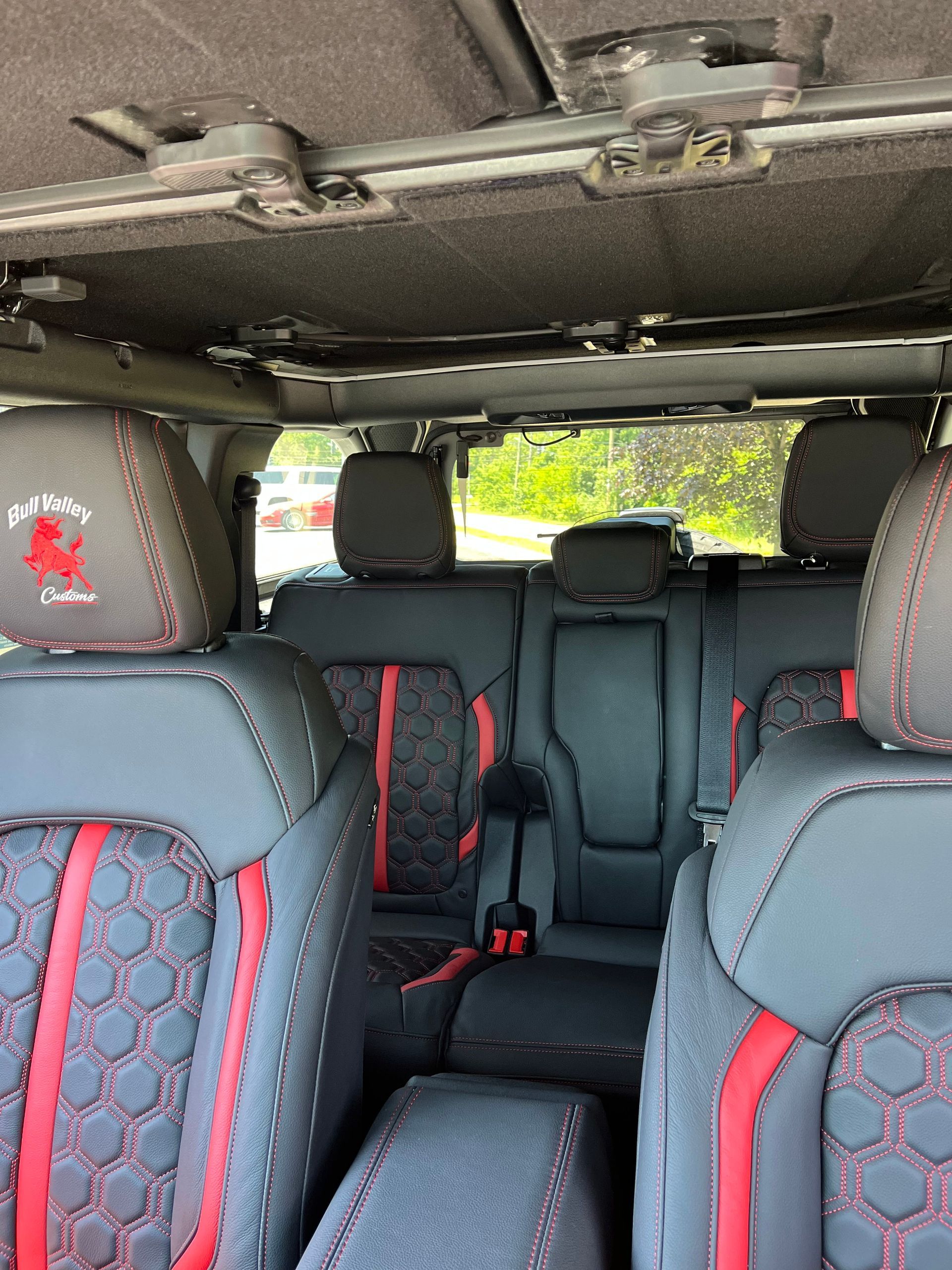 Empty car interior with patterned seat covers and a clear rear view through the windshield