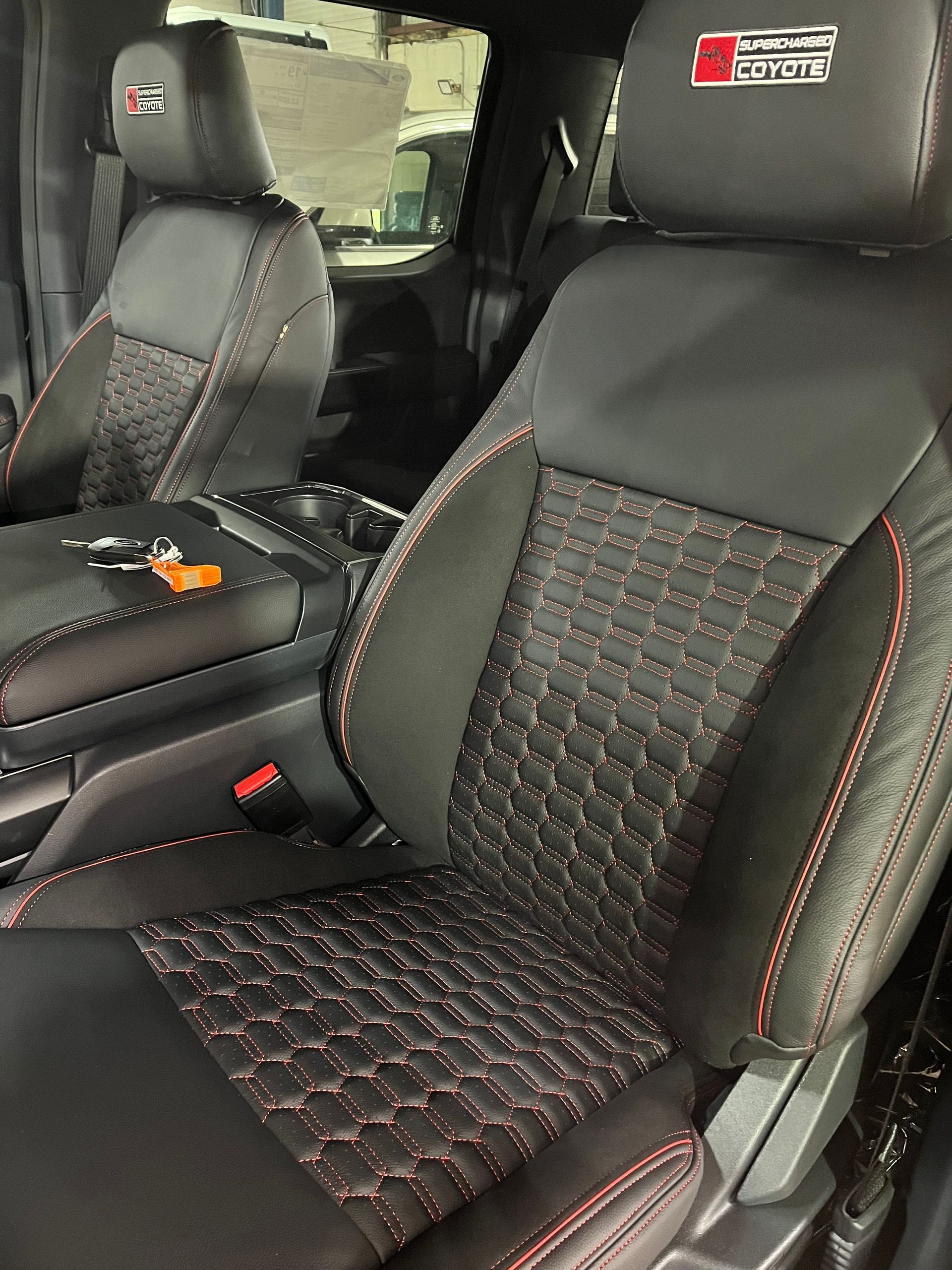 Car interior with black seats featuring red stitching