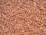 A close up of a pile of brown gravel.