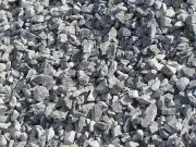 A pile of gravel is sitting on the ground.