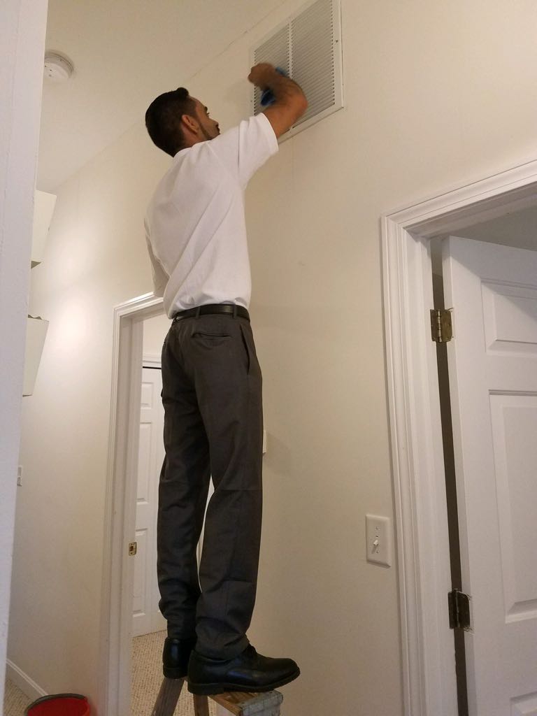 Man cleaning the vent