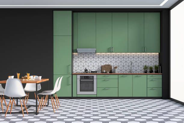 Green kitchen with matching cabinets and countertops, patterned tile floor, dining table with white chairs.