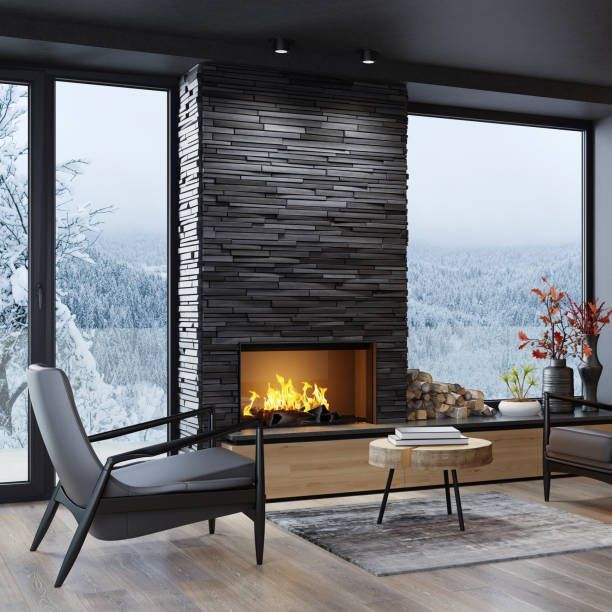 Cozy living room with fireplace, snowy mountain view, black stone, wooden accents, modern chairs, fire burning.