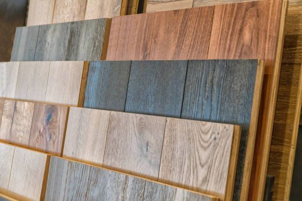 Wooden flooring samples in various colors, arranged for display.