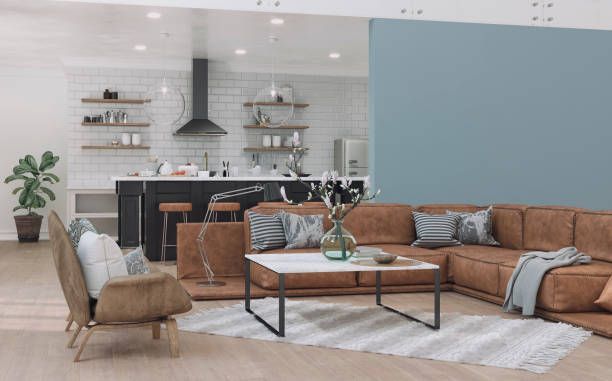 Modern open-plan living space with a kitchen, sectional sofa, and a coffee table.