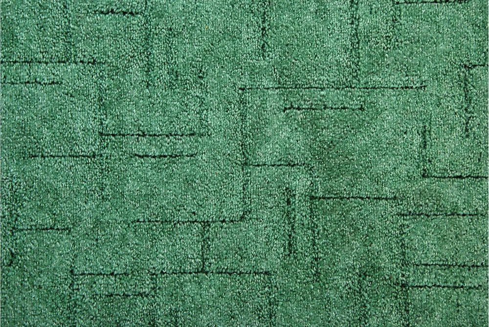 Green textured surface with black horizontal and vertical lines, like a brick wall.