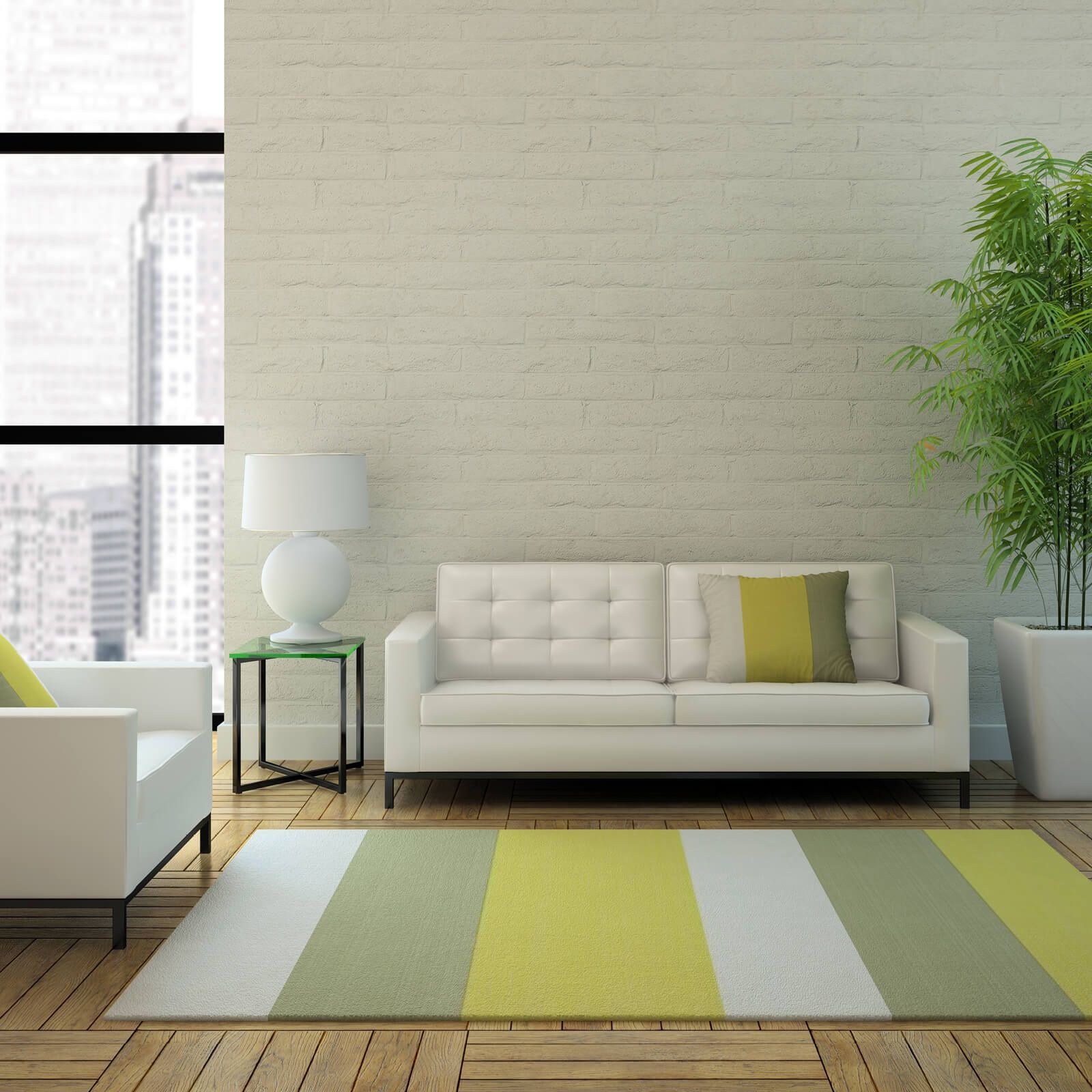 Living room with white sofa, armchair, green rug, and potted plant.