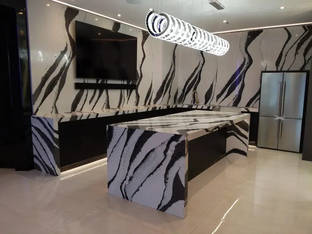 Modern kitchen with black-and-white zebra-pattern cabinets, glossy counters, and stainless steel appliances