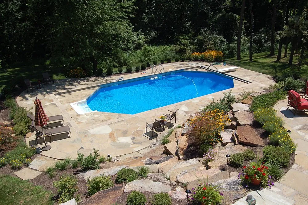 An aerial view of a large swimming pool in a backyard