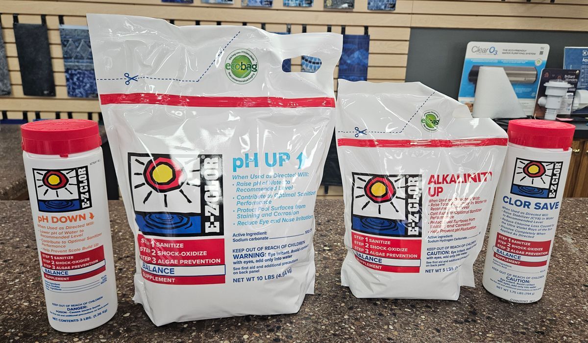 A bunch of bottles and bags of chemicals are sitting on a counter.