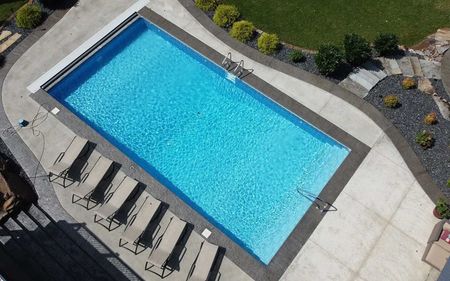 An aerial view of a large swimming pool surrounded by chairs.