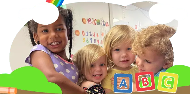 a group of children are posing for a picture with abc blocks in the background