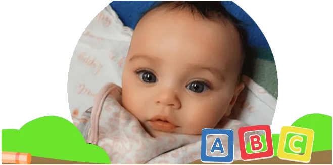 a baby wrapped in a blanket with abc blocks in the background
